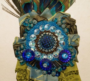 Beaded peacock corsage with central glass button