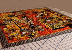 A contemprary art quilt being blocked on a pinning board