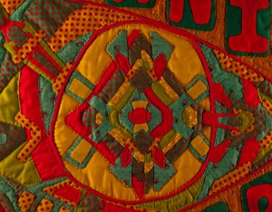 Detail photo of hand appliqued and quilted art quilt, "A Processional Banner for an Ethnic Parade"