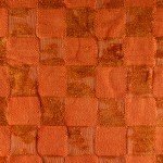 Section of an orange chenille bathmat