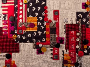 Detail of contemporary art quilt, embellished with buttons - "Graffiti"