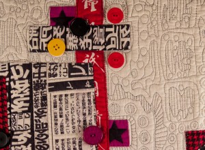 Detail of contemporary art quilt, embellished with buttons - "Graffiti"
