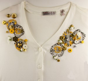 Commerical white sweater embellished with handmade appliques and buttons and beads