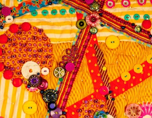 Detail of art quilt "Fiesta" basted togethe