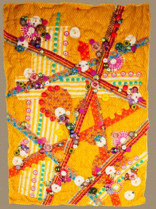 The art quilt "Fiesta" basted to bead & quilt